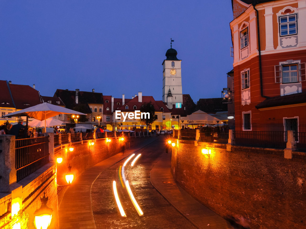 ILLUMINATED BUILDINGS AGAINST SKY AT NIGHT
