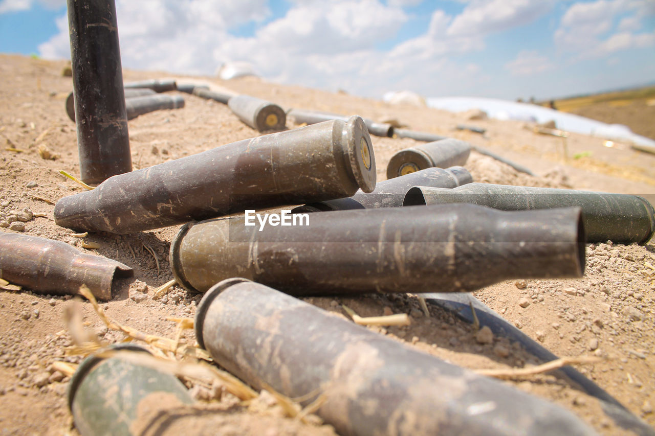 CLOSE-UP OF PIPES ON SAND