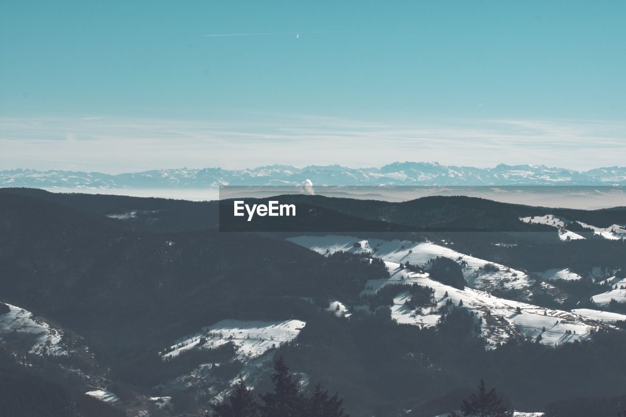 Aerial view of snowcapped mountains against sky