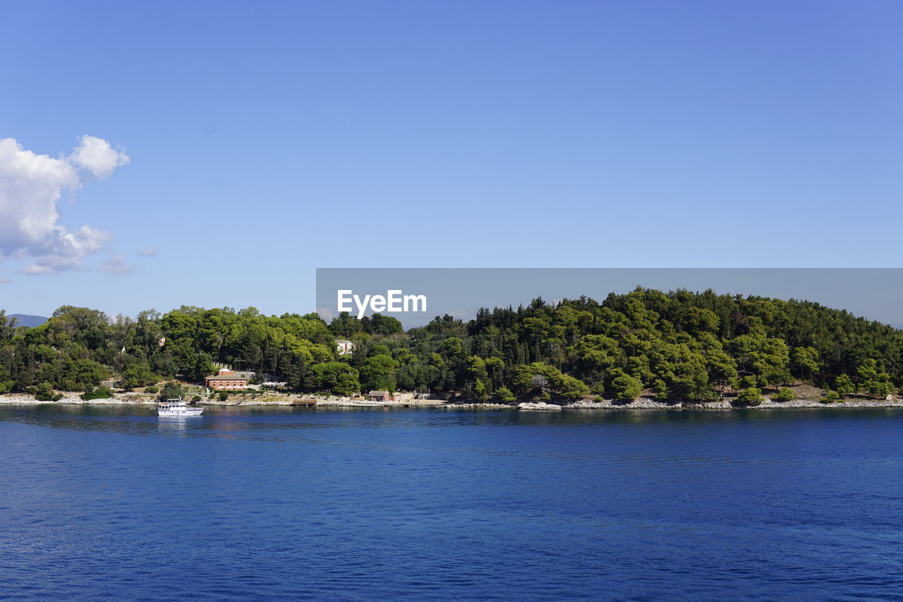 Scenic view of sea against blue sky