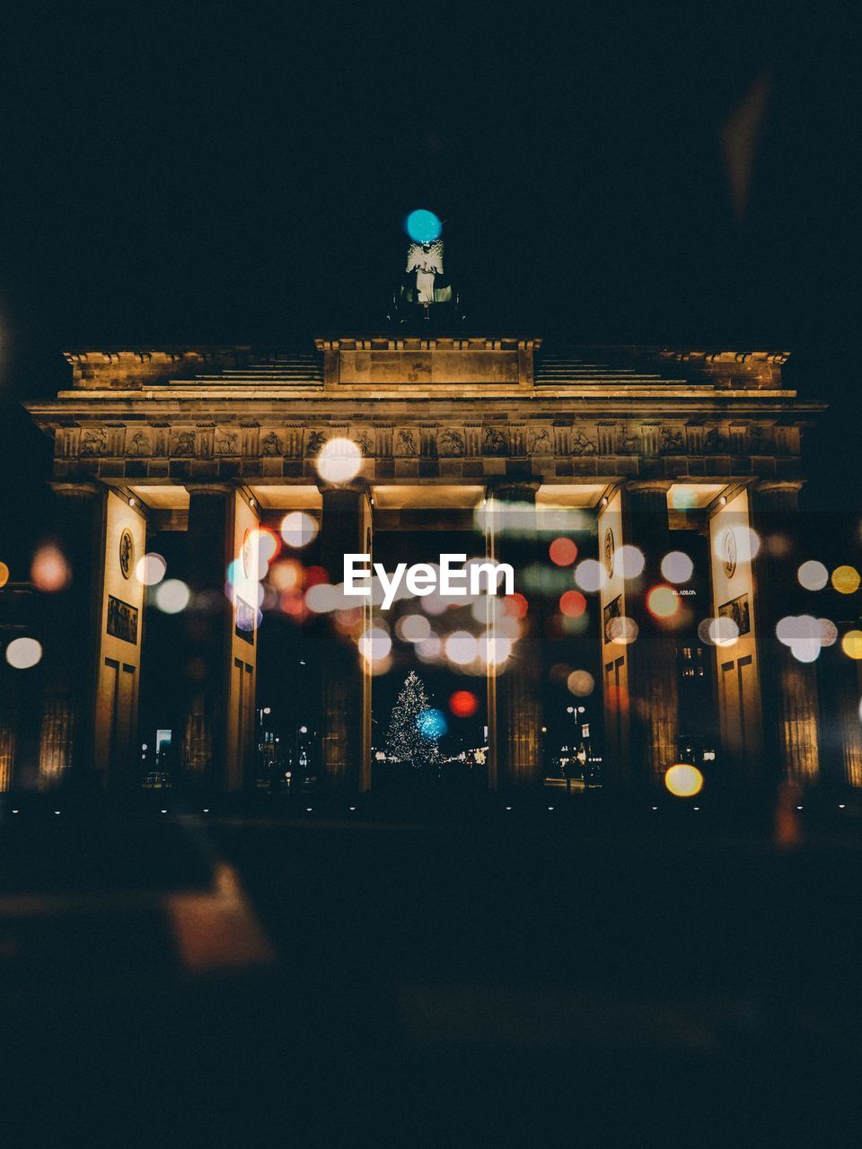 Low angle view of brandenburg gate against sky at night