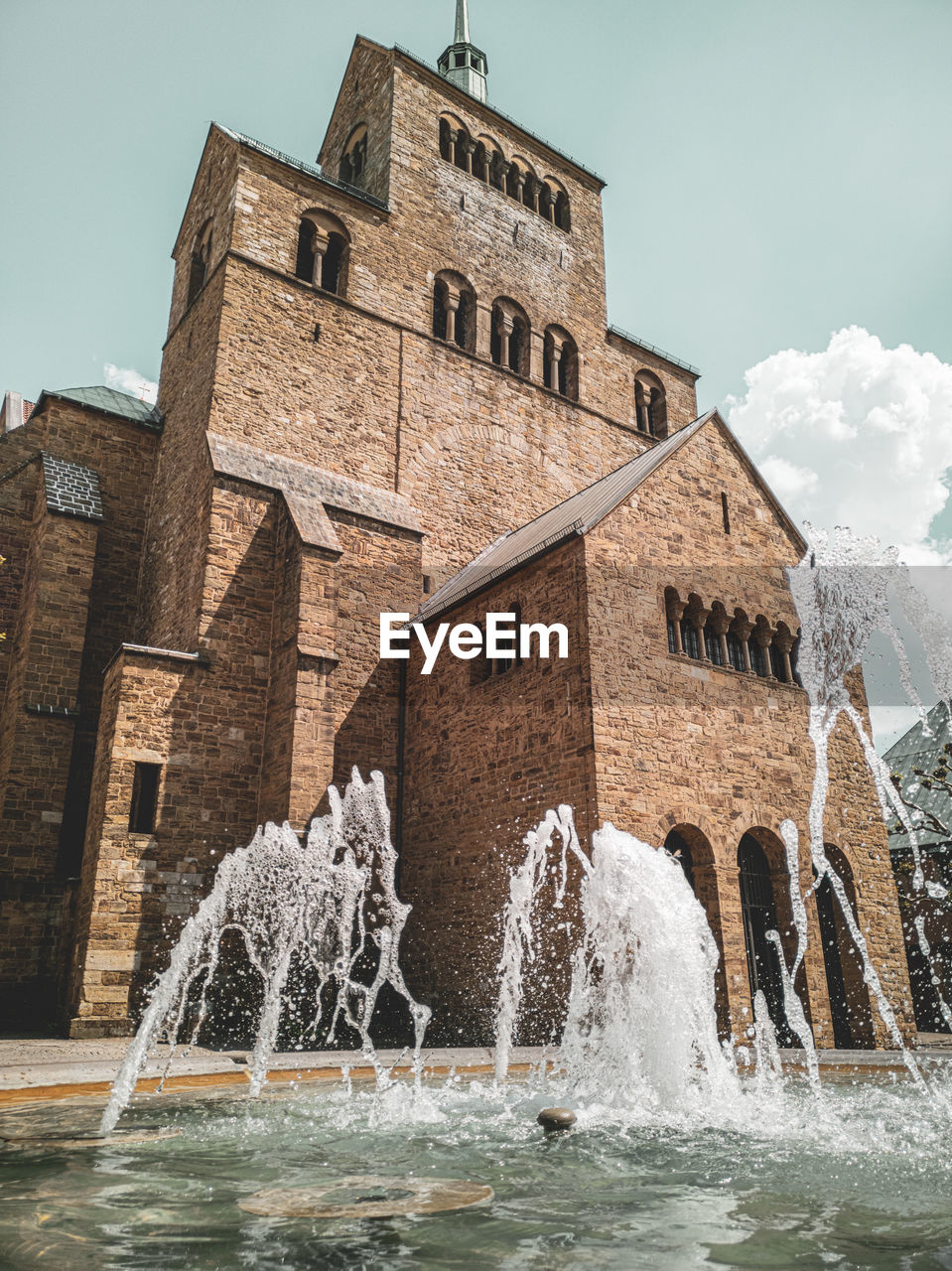 WATER FOUNTAIN BY BUILDING AGAINST SKY