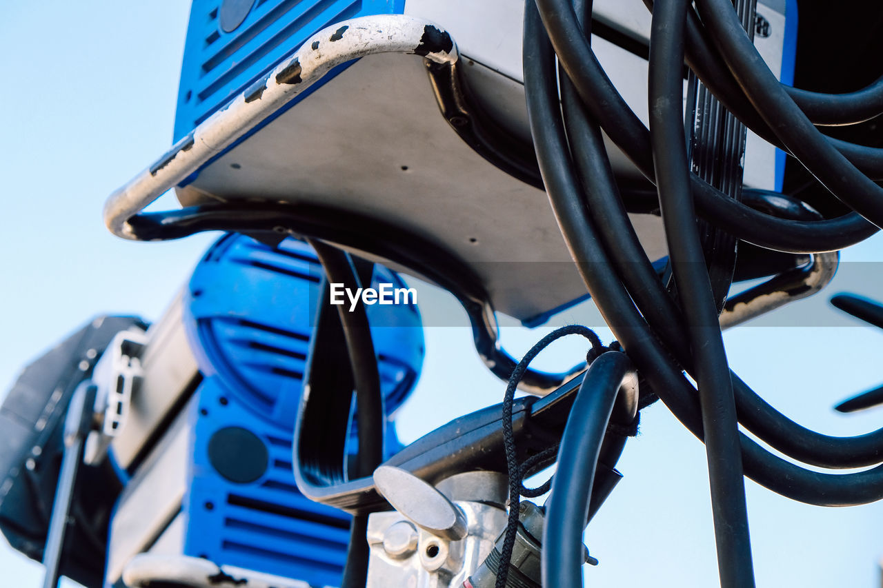 Low angle view of machine against blue sky