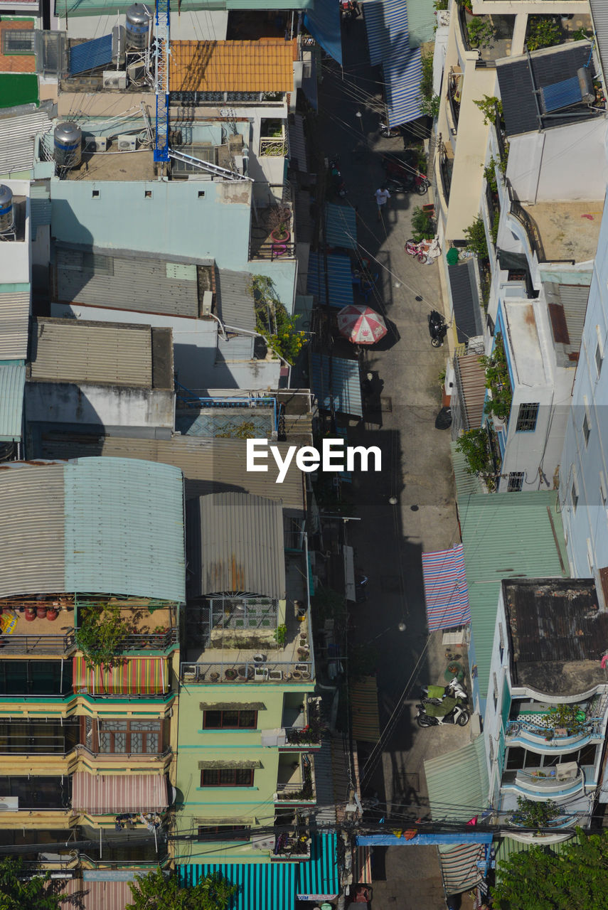 HIGH ANGLE VIEW OF STREET AMIDST BUILDINGS