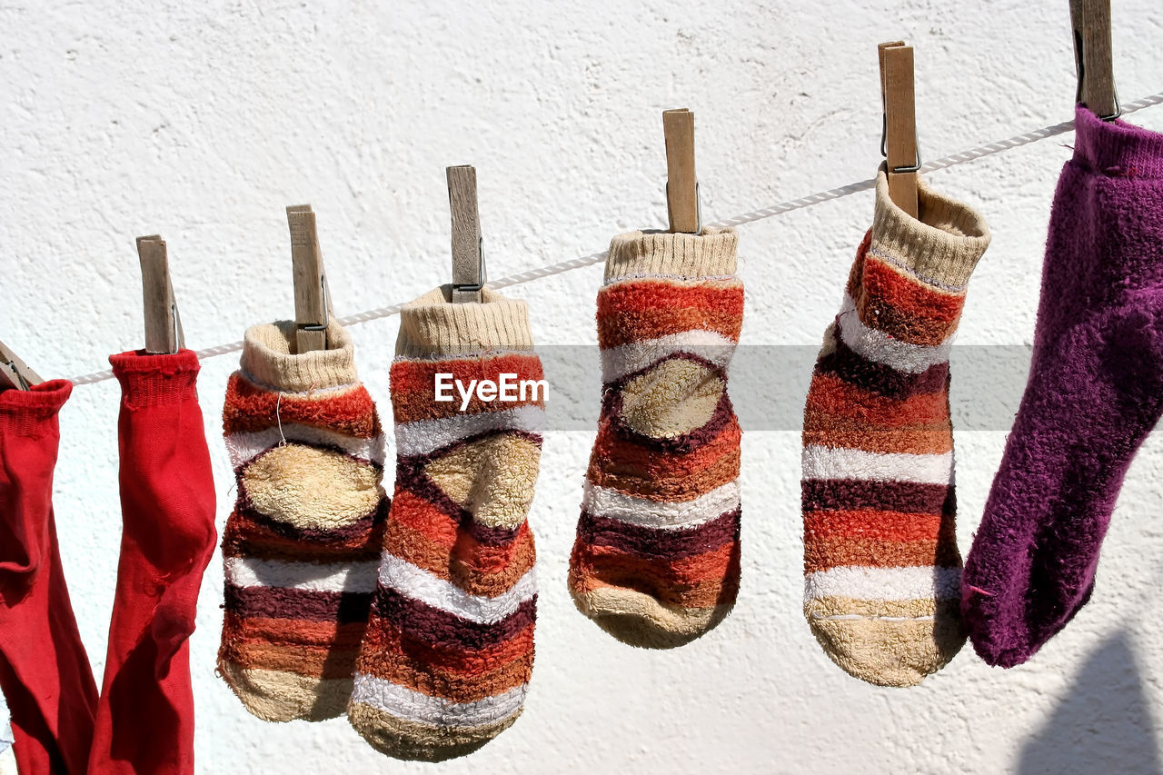 CLOSE-UP OF CLOTHES HANGING ON WALL