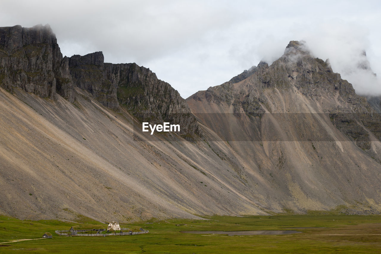 Scenic view of mountain against cloudy sky