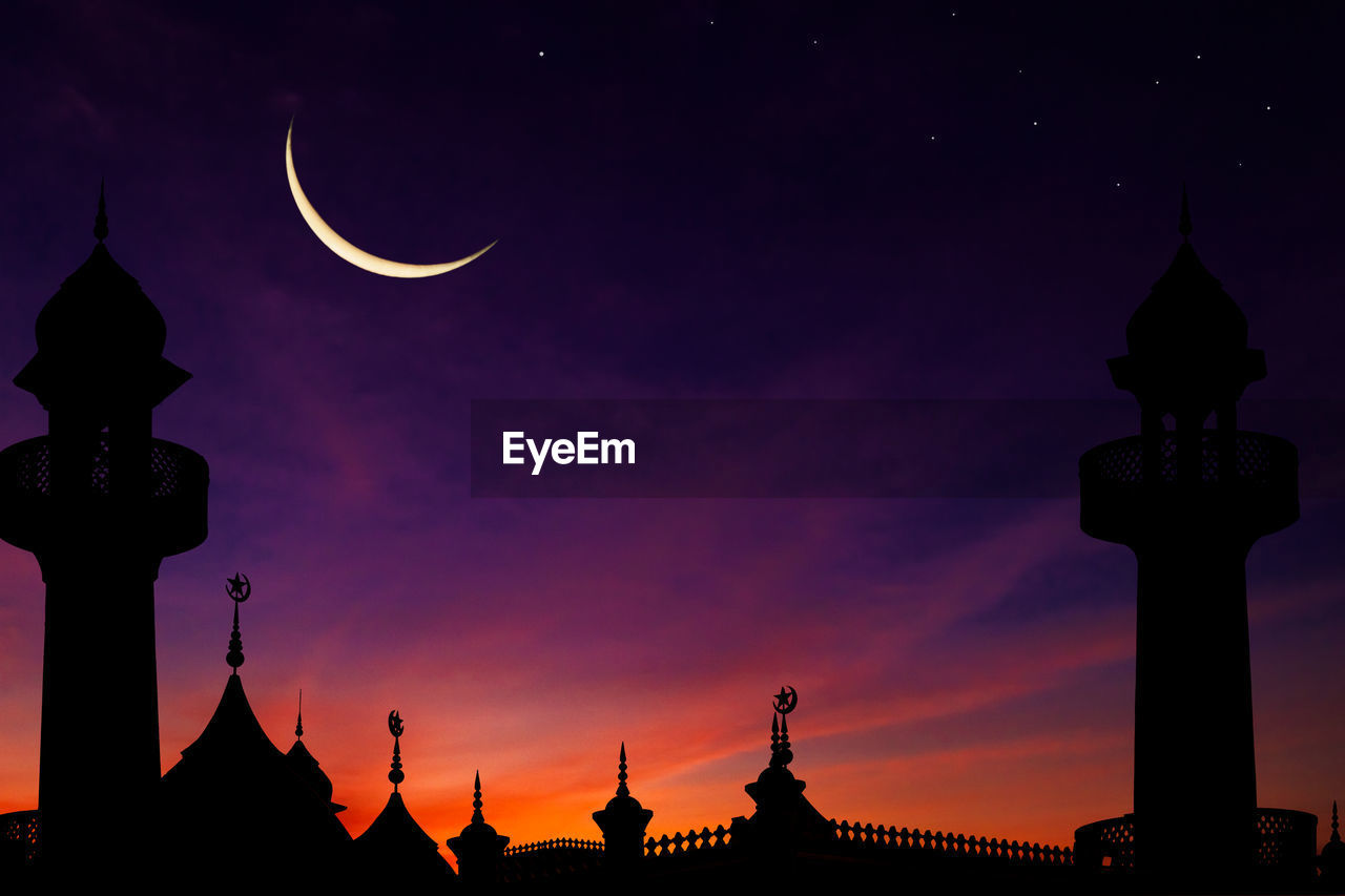 Silhouette dome mosques on twilight sky background and crescent moon