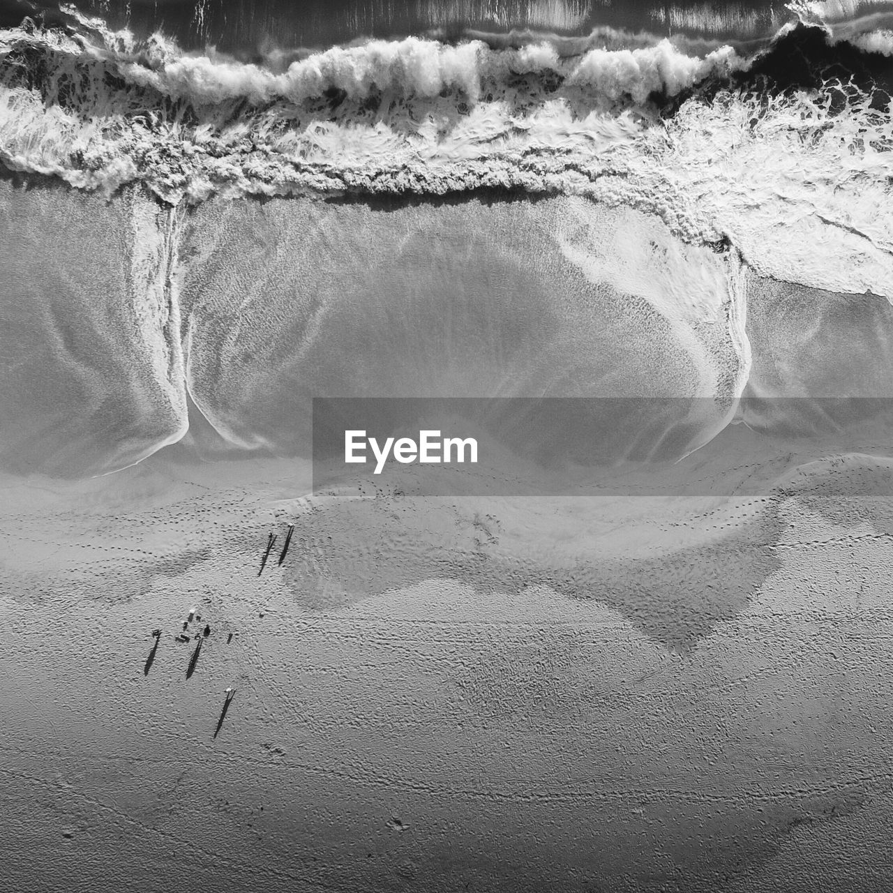 Aerial view of waves rushing towards shore