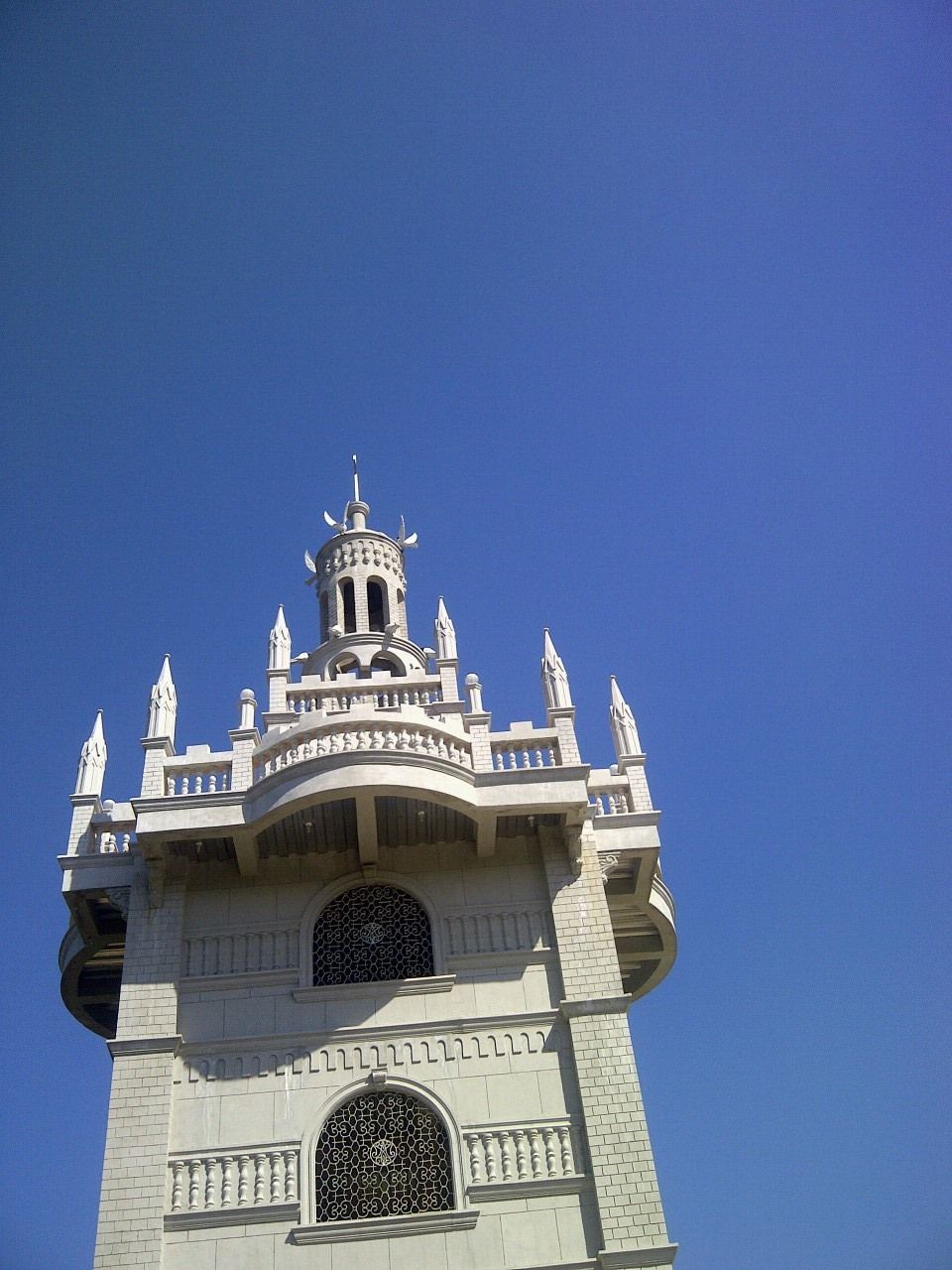 LOW ANGLE VIEW OF BUILT STRUCTURES AGAINST BLUE SKY