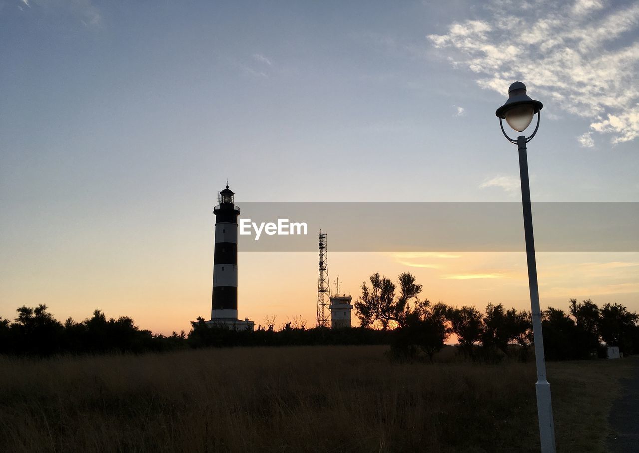 Low angle view of chassiron lighthouse against sky at sunset