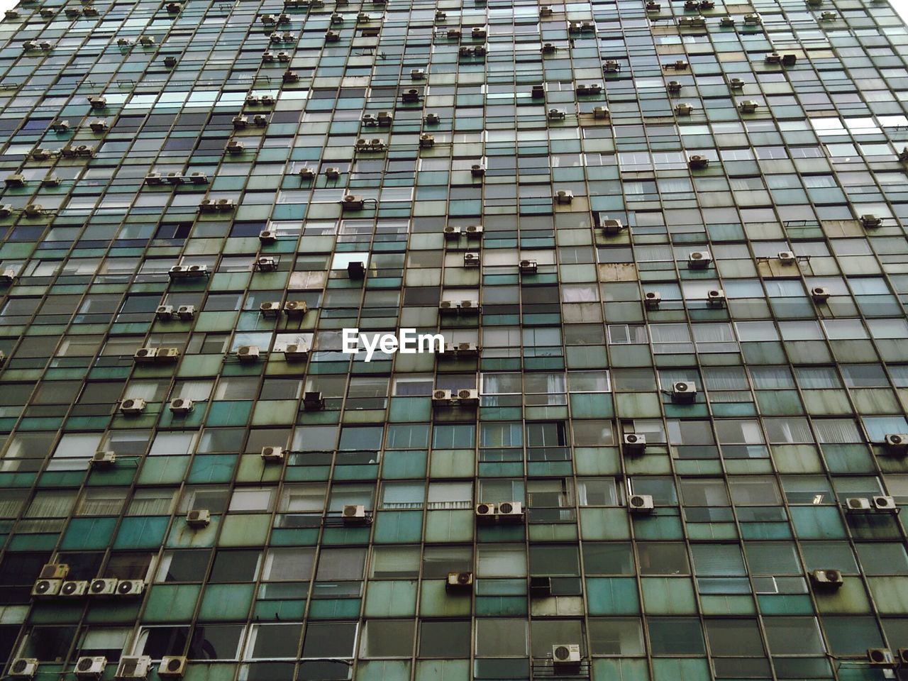 Low angle view of air conditioners on old building