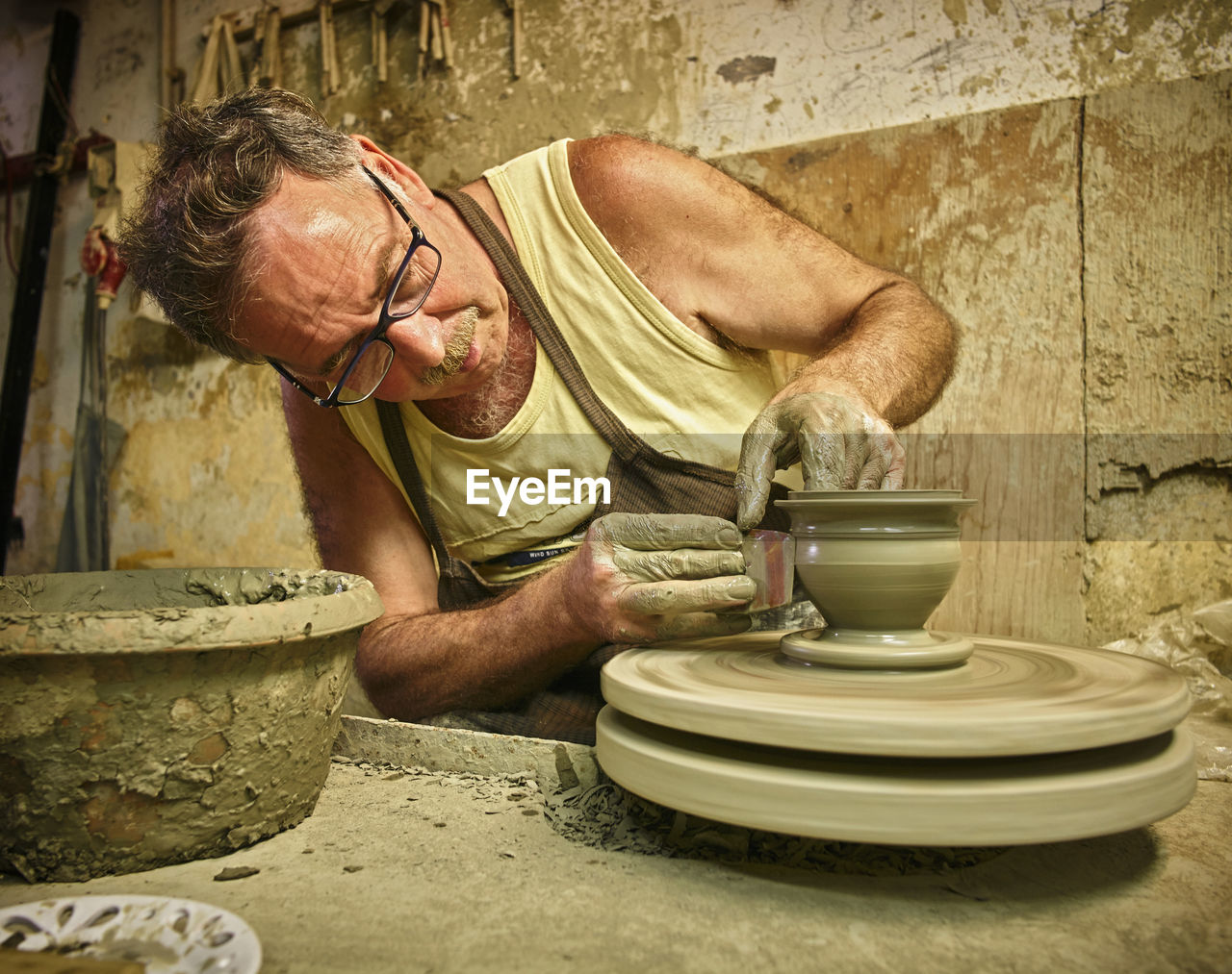 Potter in workshop working on vase