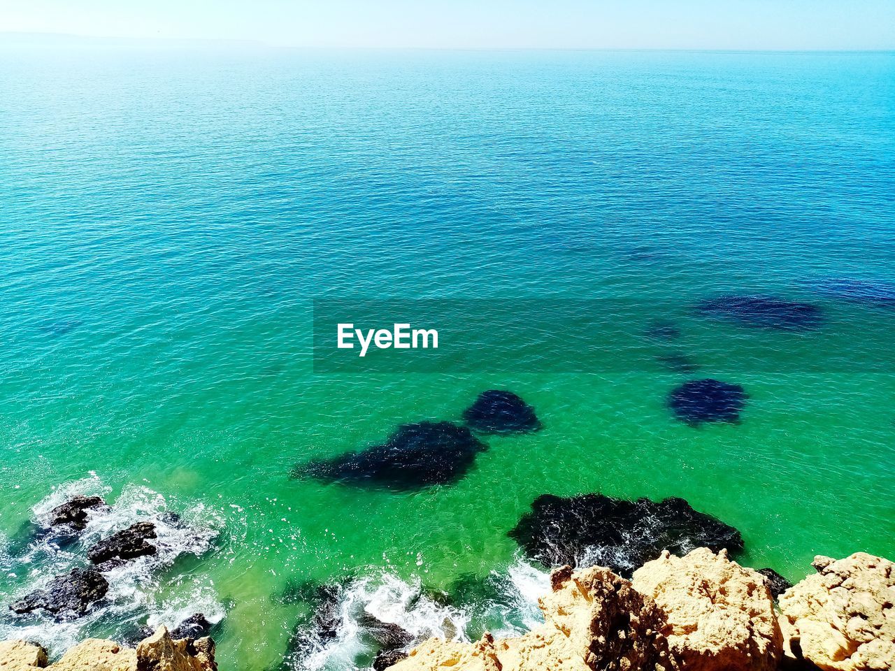 High angle view of rocks on sea shore