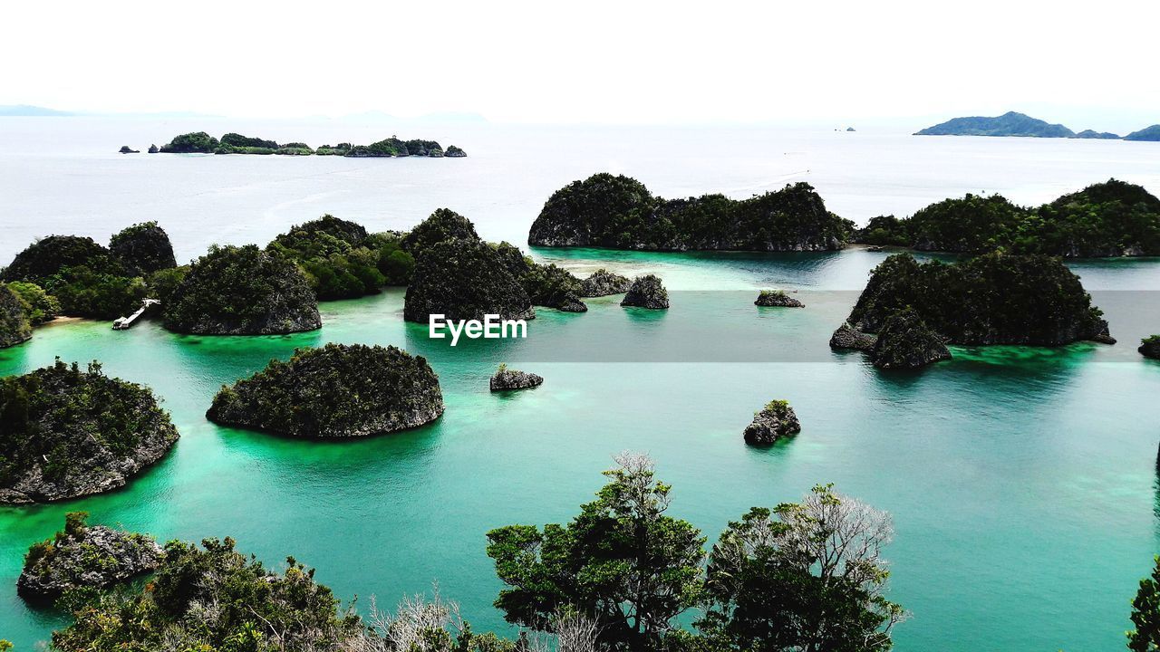 water, sea, land, scenics - nature, archipelago, beauty in nature, islet, sky, nature, tranquility, beach, rock, island, tranquil scene, bay, lagoon, coast, no people, travel destinations, idyllic, environment, travel, coastline, outdoors, horizon over water, reef, turquoise colored, day, tree, plant, landscape, ocean, shore, holiday, bay of water, tropical climate, tourism, blue, cove, coral, trip, horizon