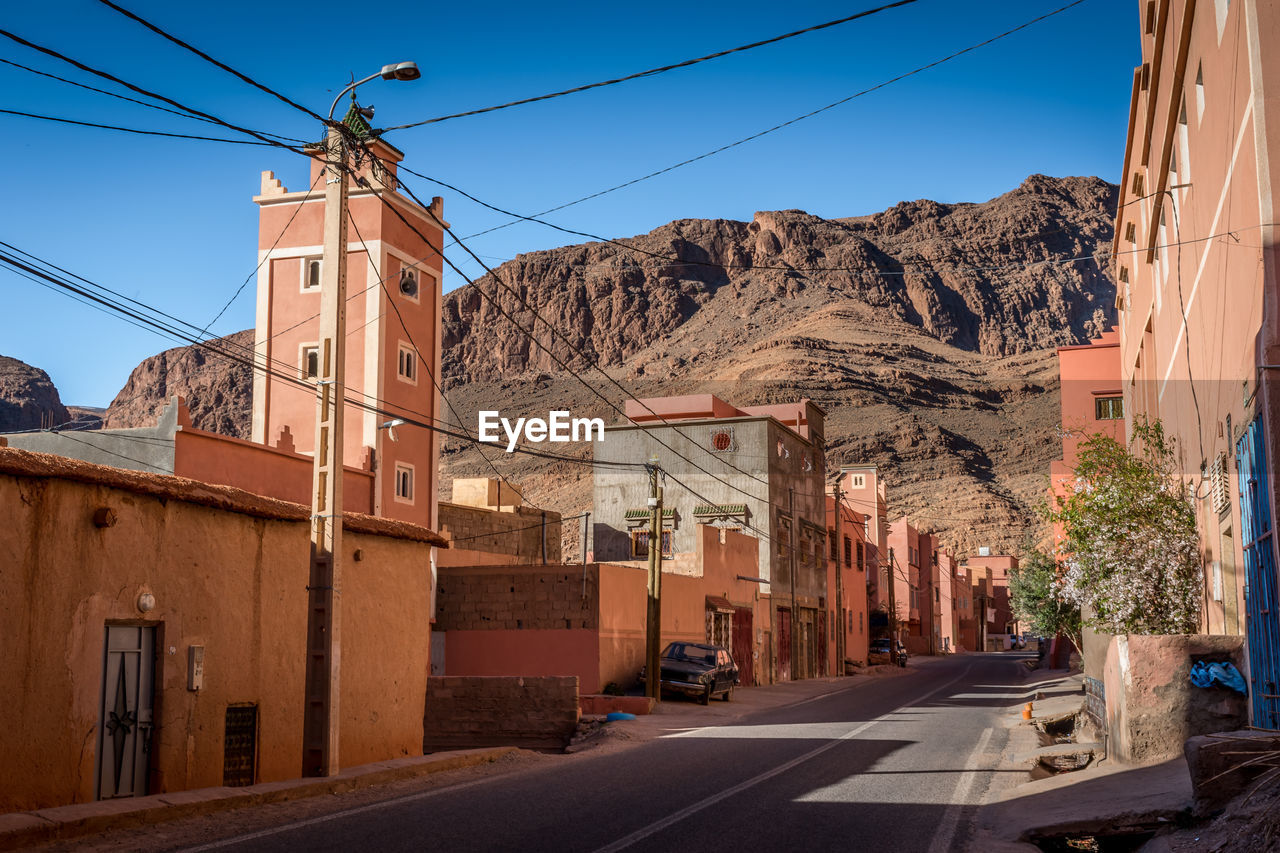 ROAD AMIDST BUILDINGS IN CITY