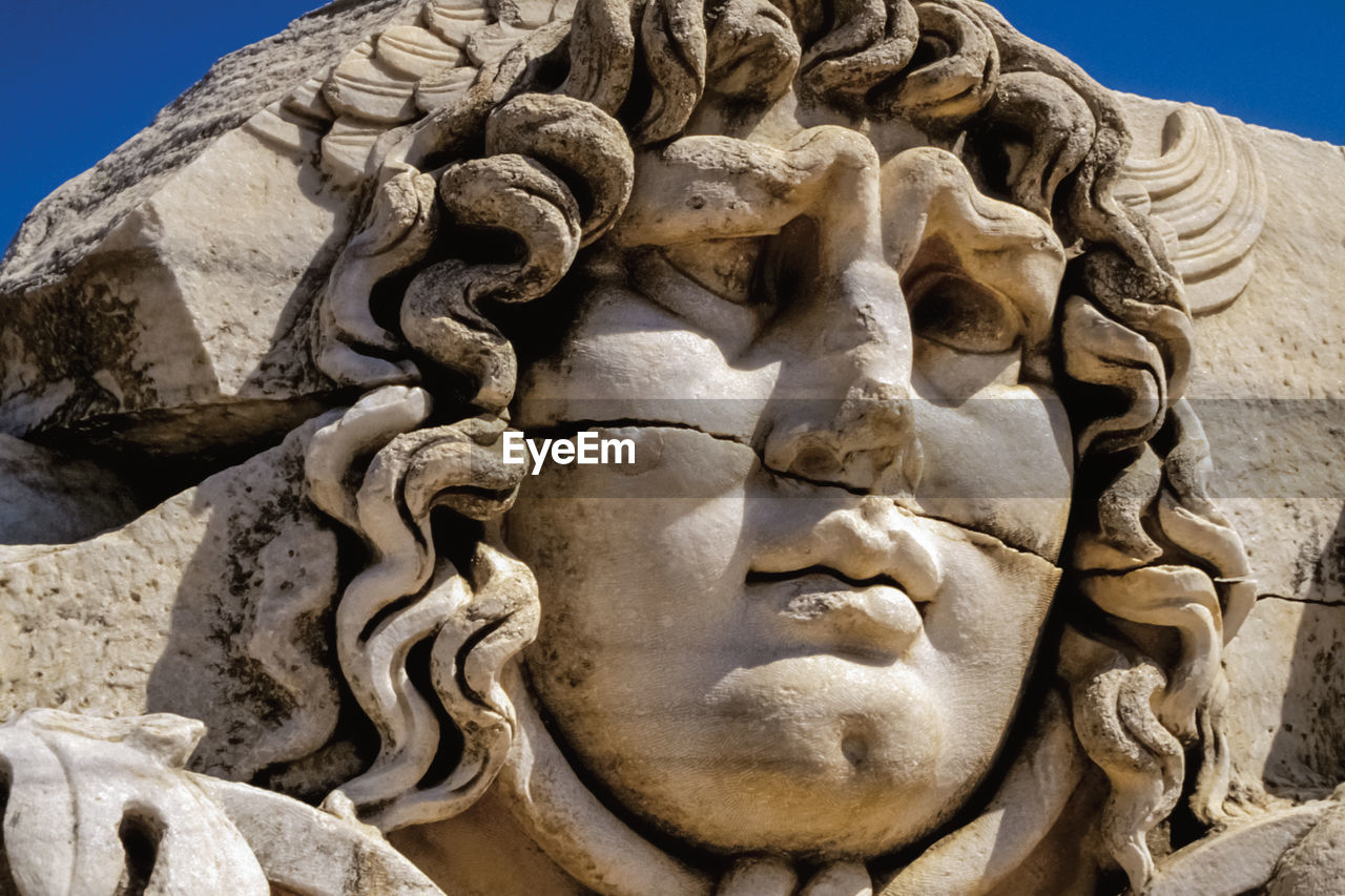 Face carved on marble in classical style by ancient greeks at the apollo's temple in didyma, turkey.