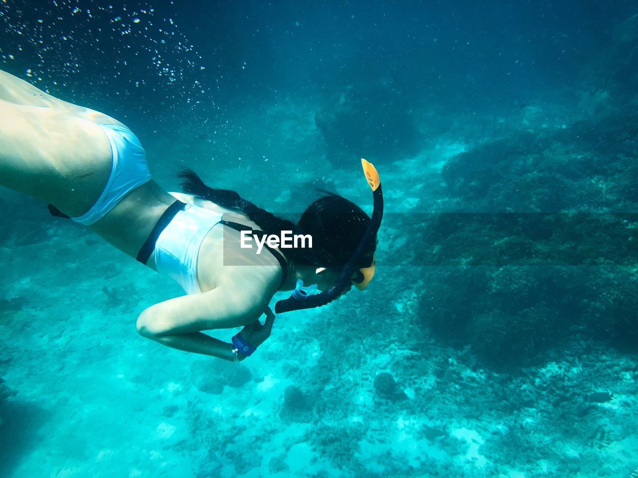 High angle view of woman swimming underwater in sea