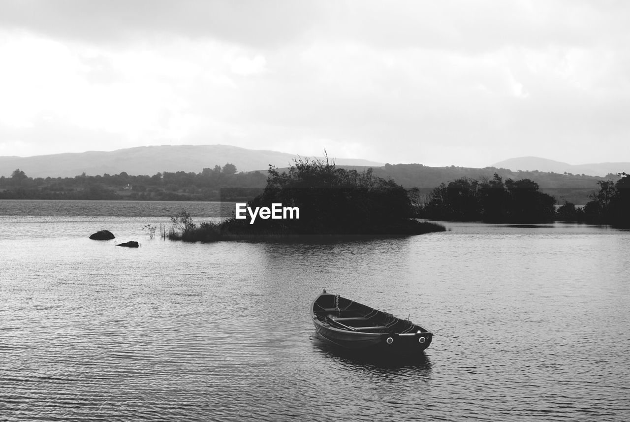 Abandoned boat in calm lake