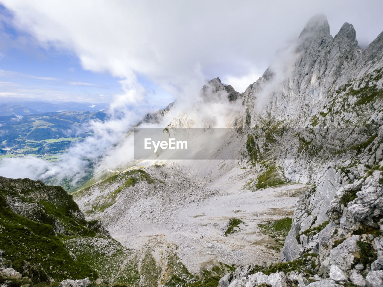 scenic view of mountains against cloudy sky