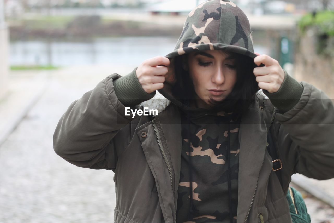 Close-up of beautiful young woman in warm clothes