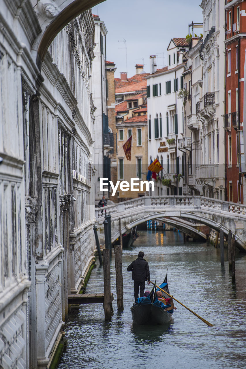 Gondola on narrow canal in venice