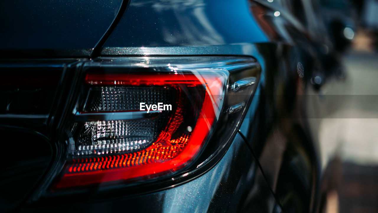 Close-up of black car, rear taillights