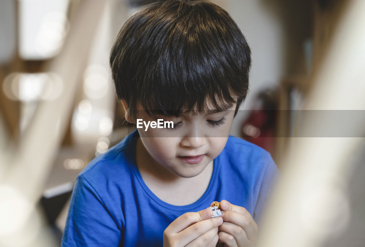 Close-up of boy playing at home