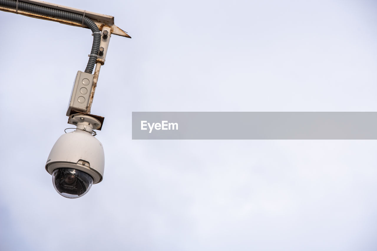 LOW ANGLE VIEW OF ELECTRIC LAMP AGAINST SKY