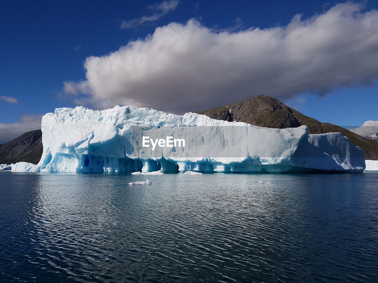 Scenic view of a big greenland iceberg floating on the arctic sea