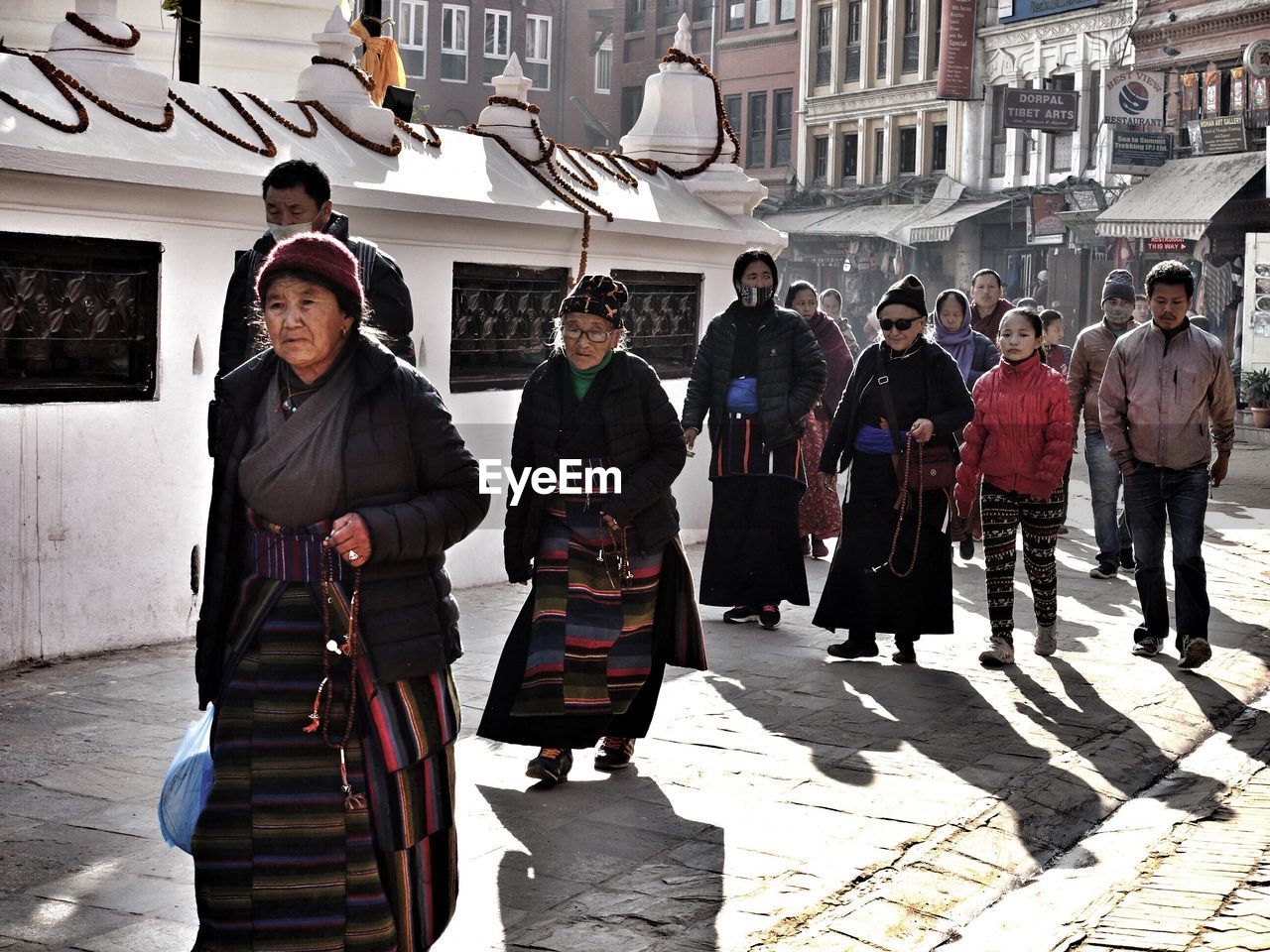 PEOPLE WALKING ON STREET IN CITY