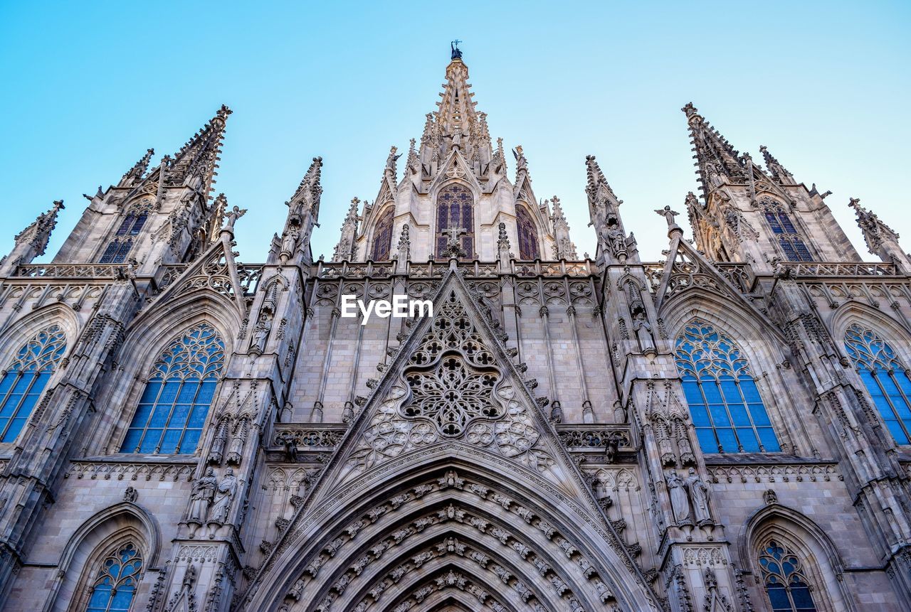Low angle view of barcelona cathedral against clear sky in city