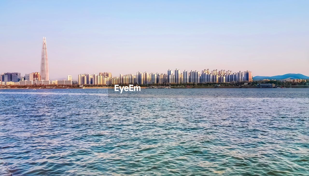 Sea with buildings in background