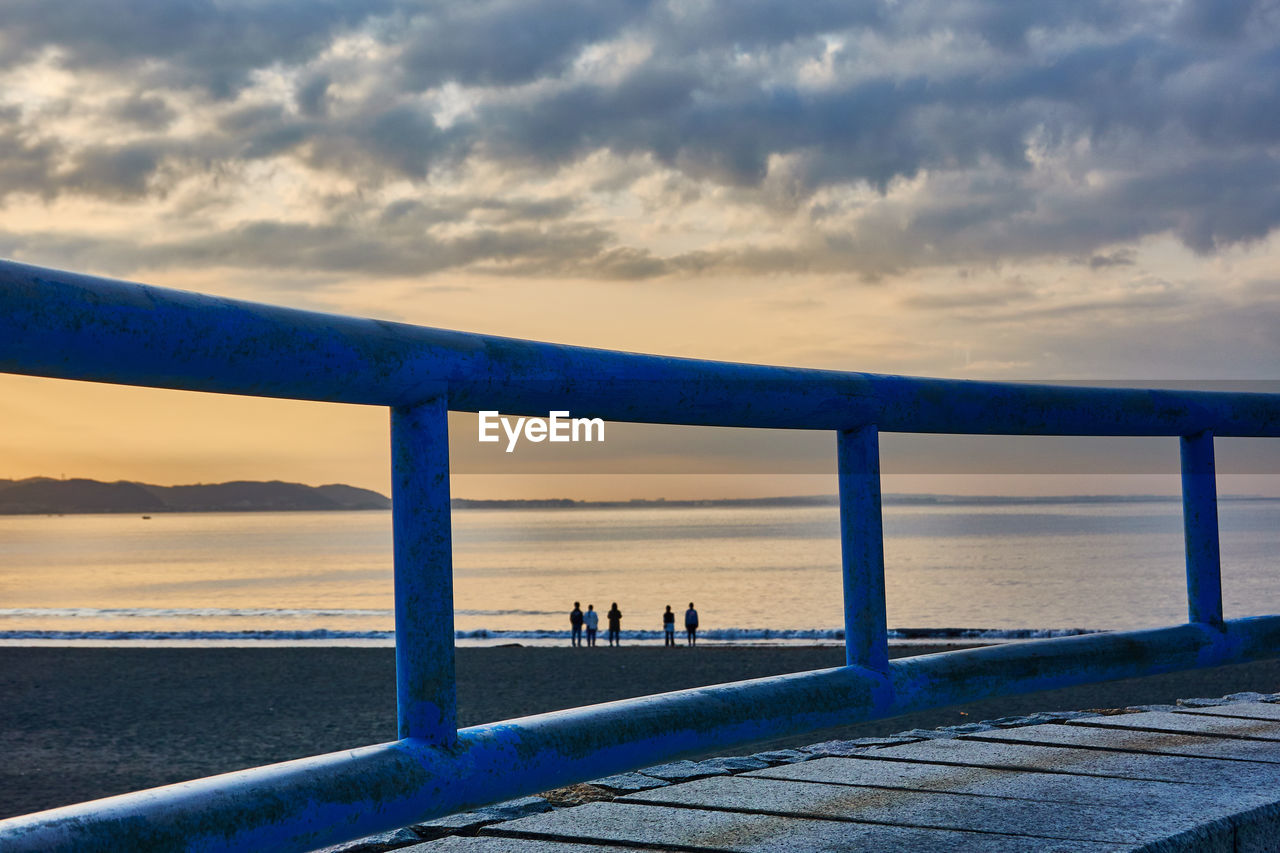 Pier over sea against sky during sunrise