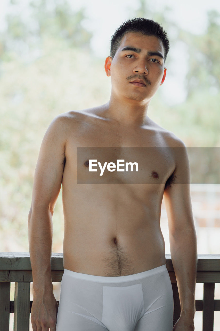barechested, men, one person, young adult, briefs, undergarment, portrait, adult, standing, underpants, looking at camera, three quarter length, clothing, lifestyles, person, serious, muscular build, front view, looking, photo shoot, day, waist up, sports, nature, black hair, leisure activity, outdoors, strength, focus on foreground, exercising