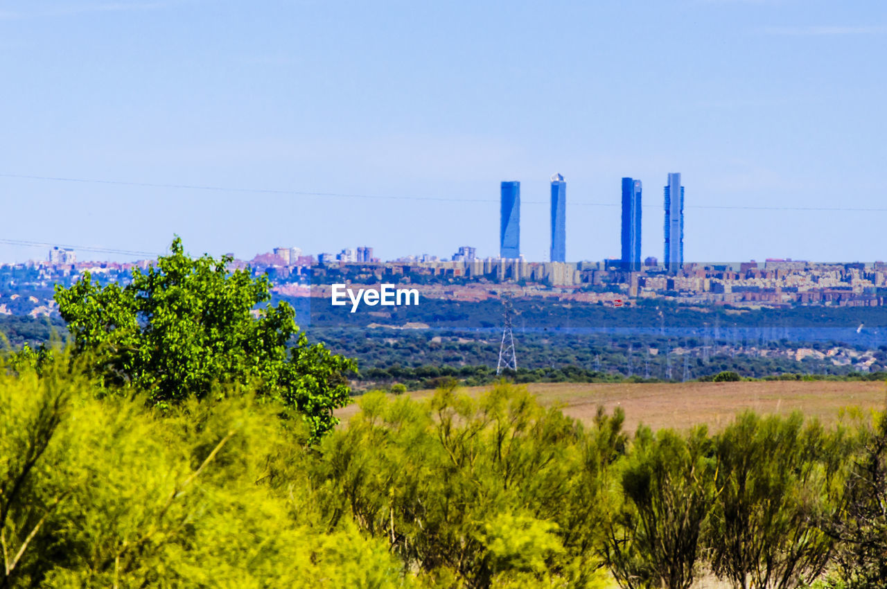 PANORAMIC VIEW OF CITY AGAINST BLUE SKY