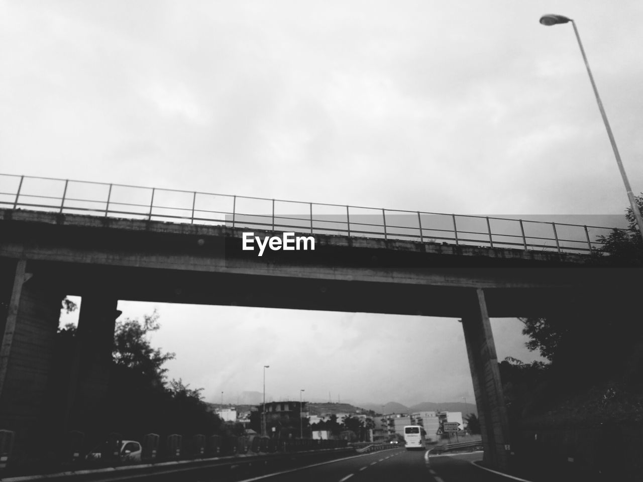 LOW ANGLE VIEW OF BRIDGE AGAINST CLOUDY SKY