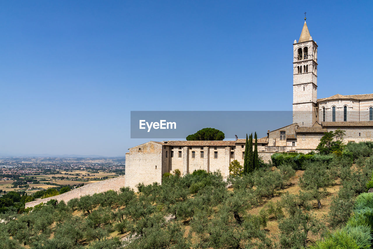 Panoramic view from assisi with the bell tower of the basilica of santa chiara, umbria, italy