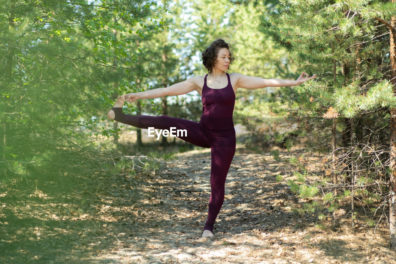 Full length of young woman exercising in park
