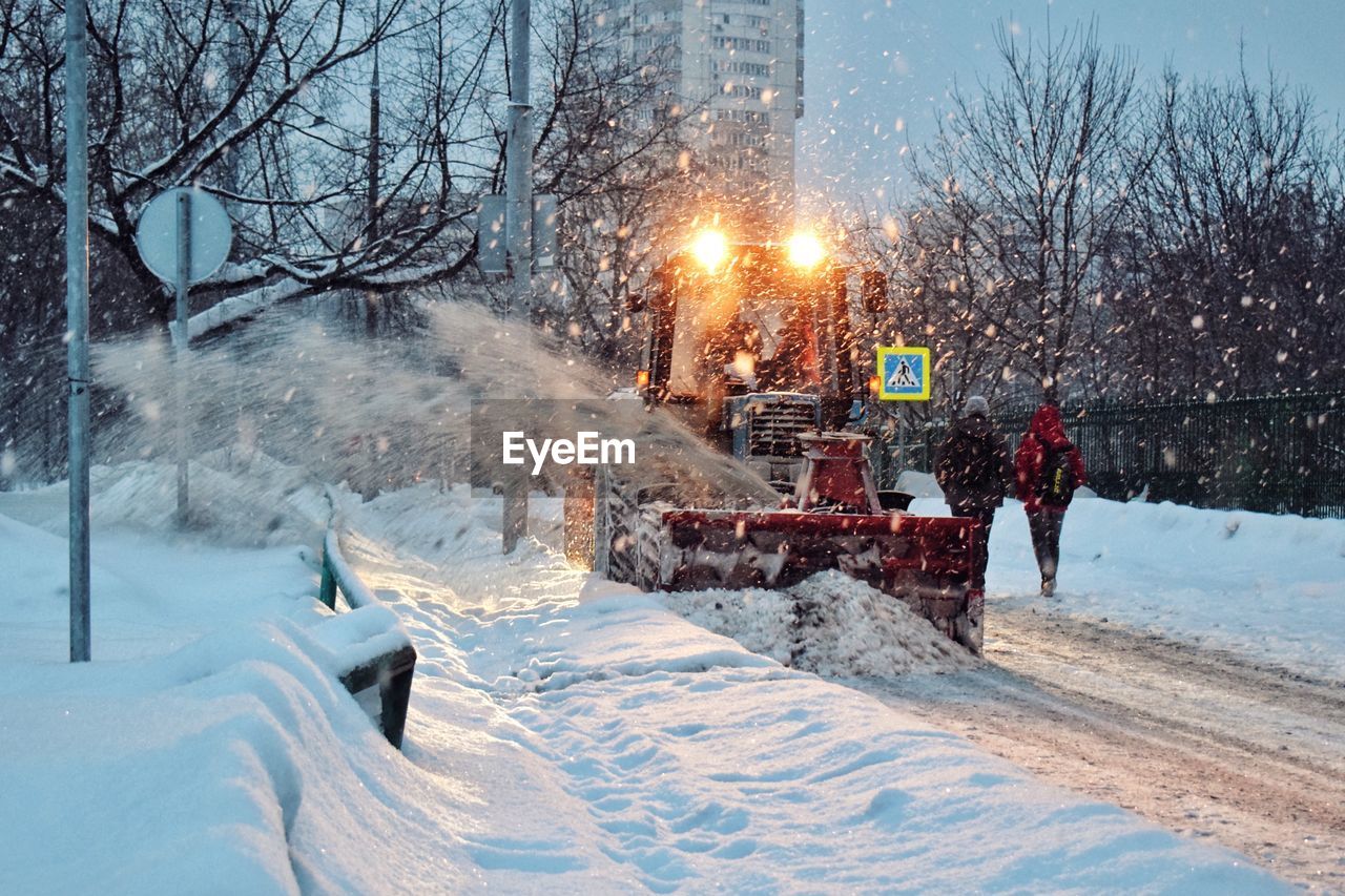 Snow covered road in city at night