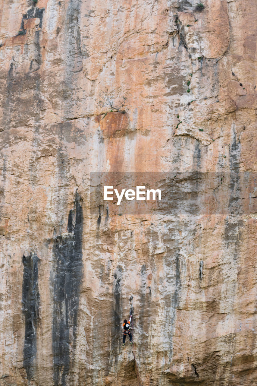 Full length of man climbing on rock formation