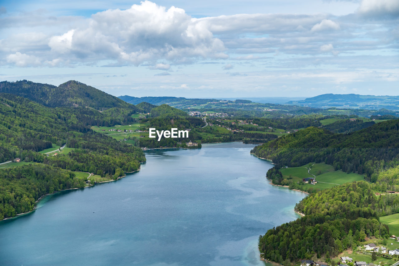 Scenic view of river amidst trees against sky