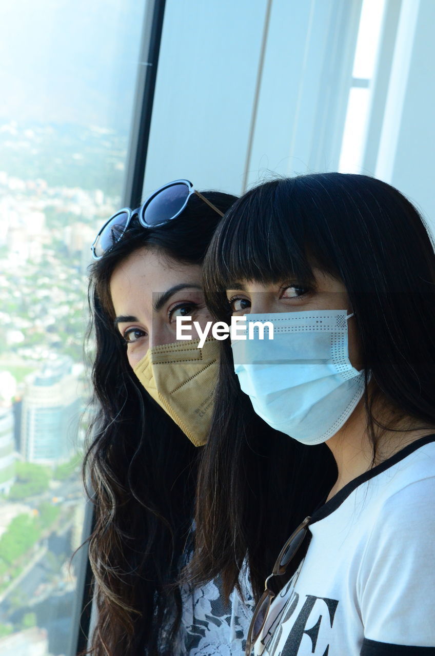 Two young sisters wearing face mask due to covid-19