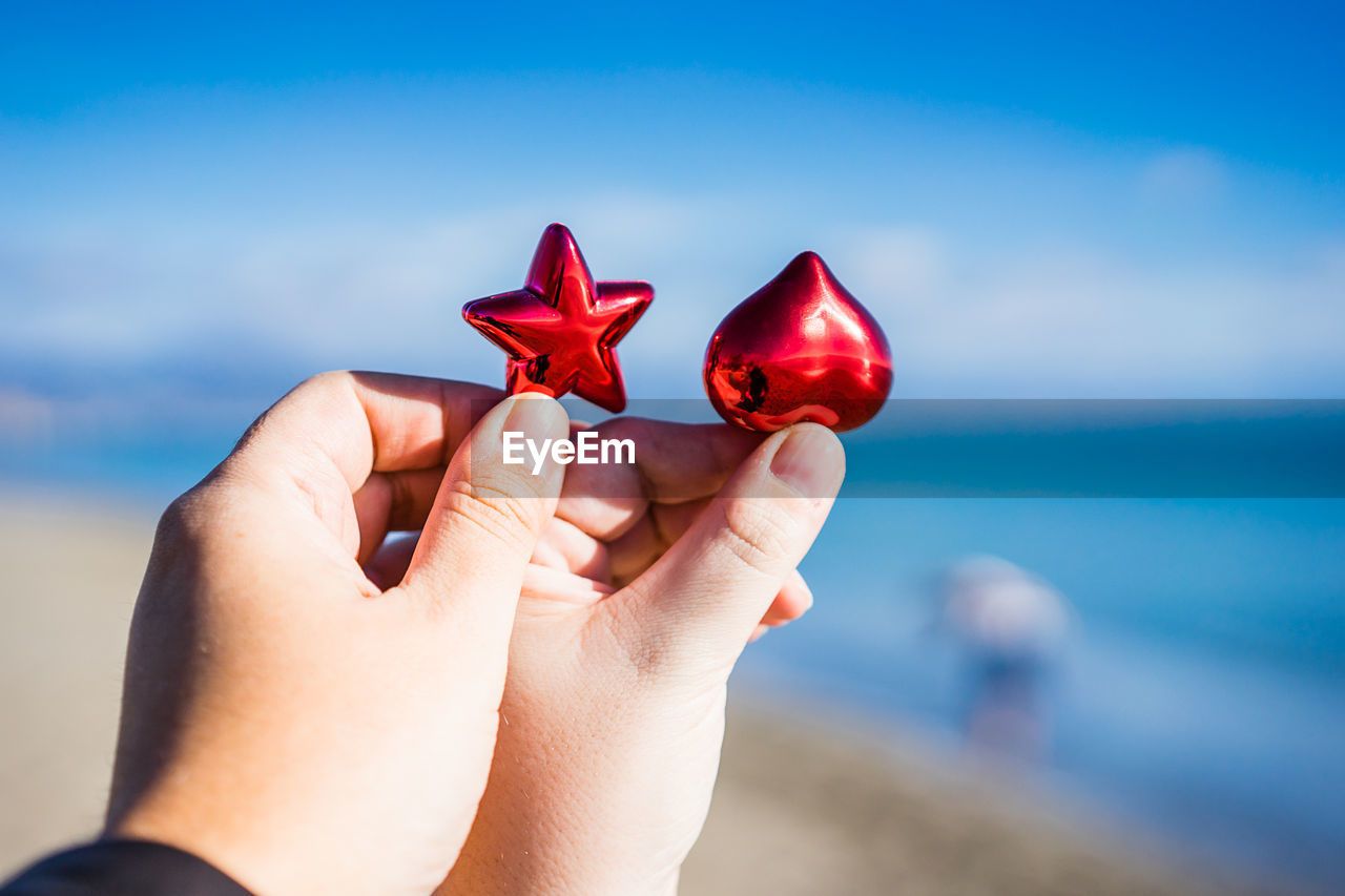 Close-up of couple holding heart shape and star shape