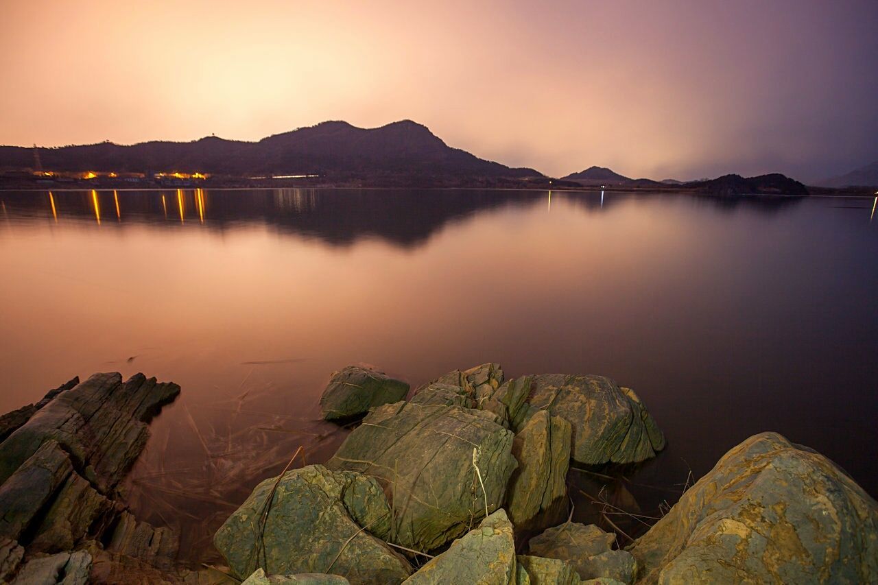 Scenic view of lake at sunset