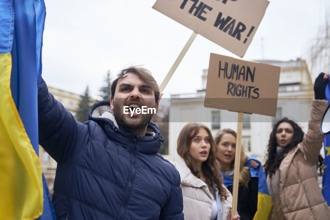 Portrait of volunteers screaming during protest