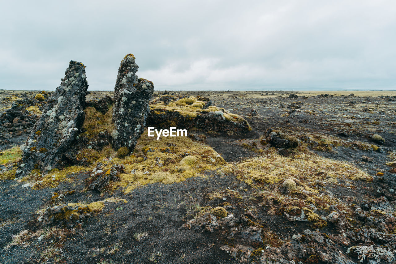 Scenic view of rock formation in sea against sky