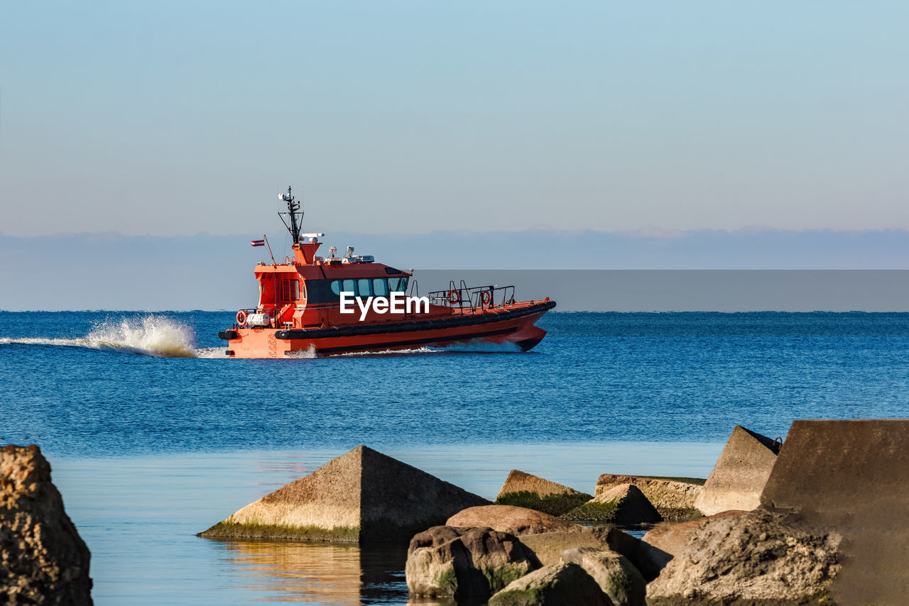 FISHING BOAT IN SEA AGAINST SKY