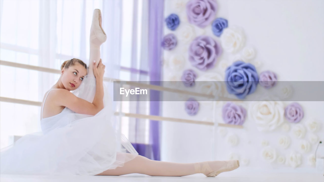 Young woman practicing ballet in studio