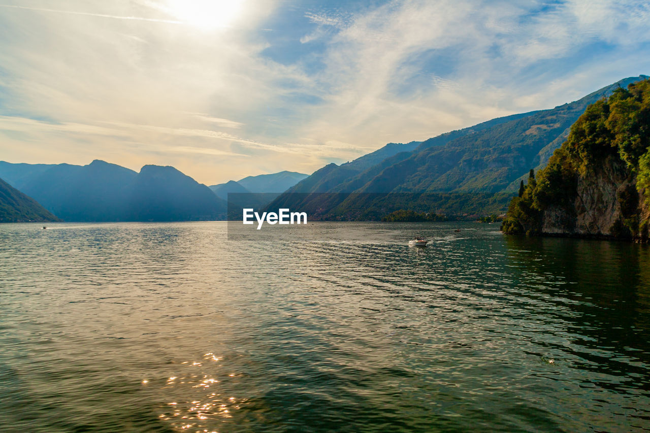 Lansdscape of lake of como from garden of villa del balbianello, lombardy, italy at sunset