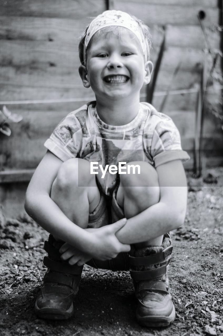 PORTRAIT OF CUTE BOY HOLDING TOY